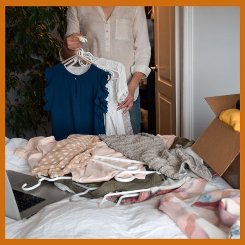 Woman sorting clothes on bed