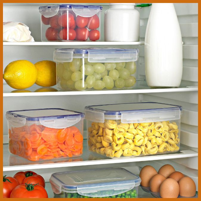 Food in clear containers on refrigerator shelves